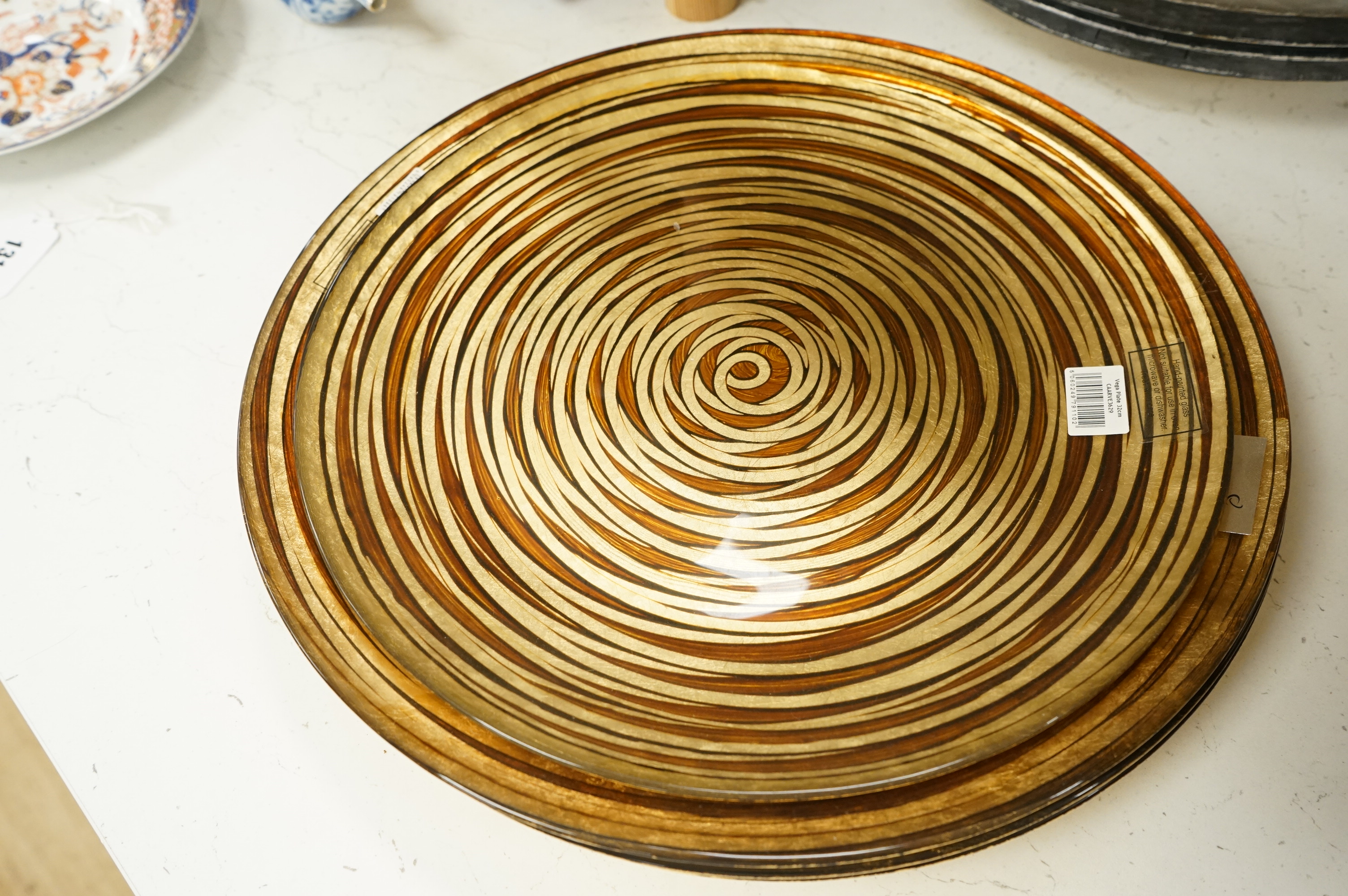 Deborah Timperley, a Studio art glass dish, 34cm, together with ten Carnelian studio glass dishes, largest 37cm